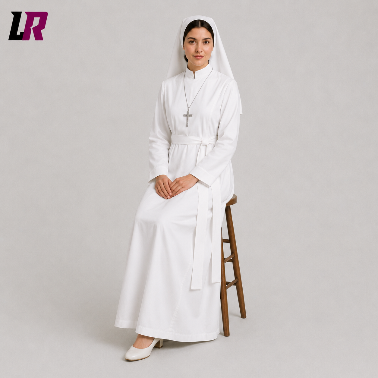 Woman sitting on a stool wearing a white nun-inspired costume with matching headpiece for cosplay and theatrical performances