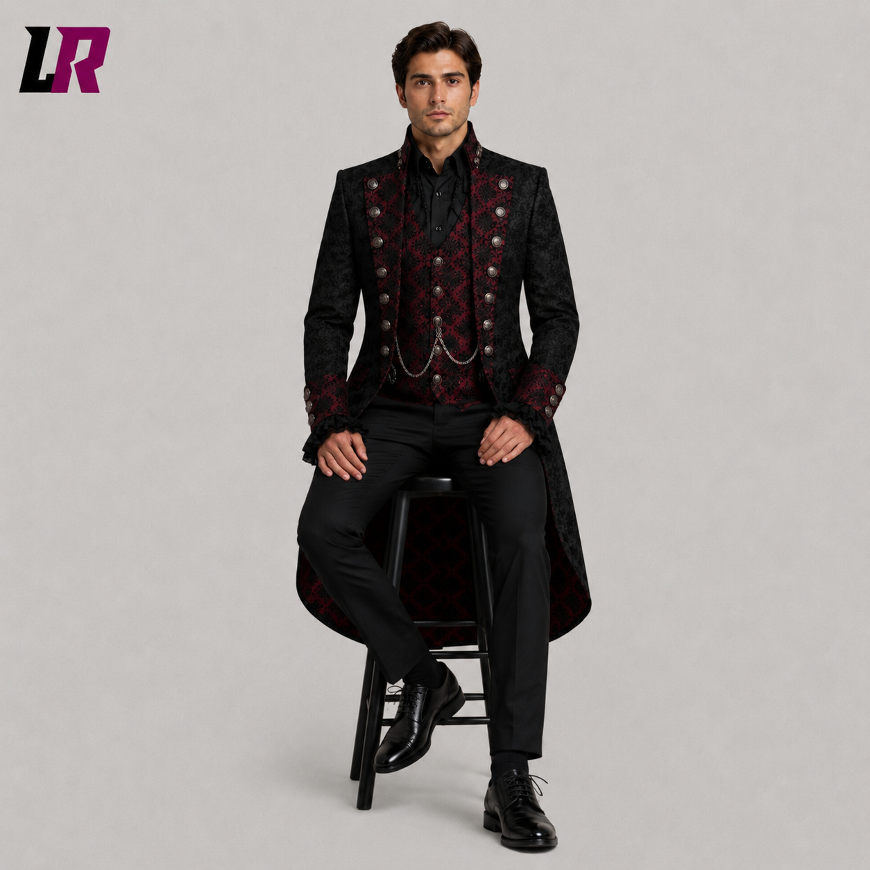 Men's black burgundy Victorian Gothic tailcoat with model seated on a stool in a luxury formal fashion pose
