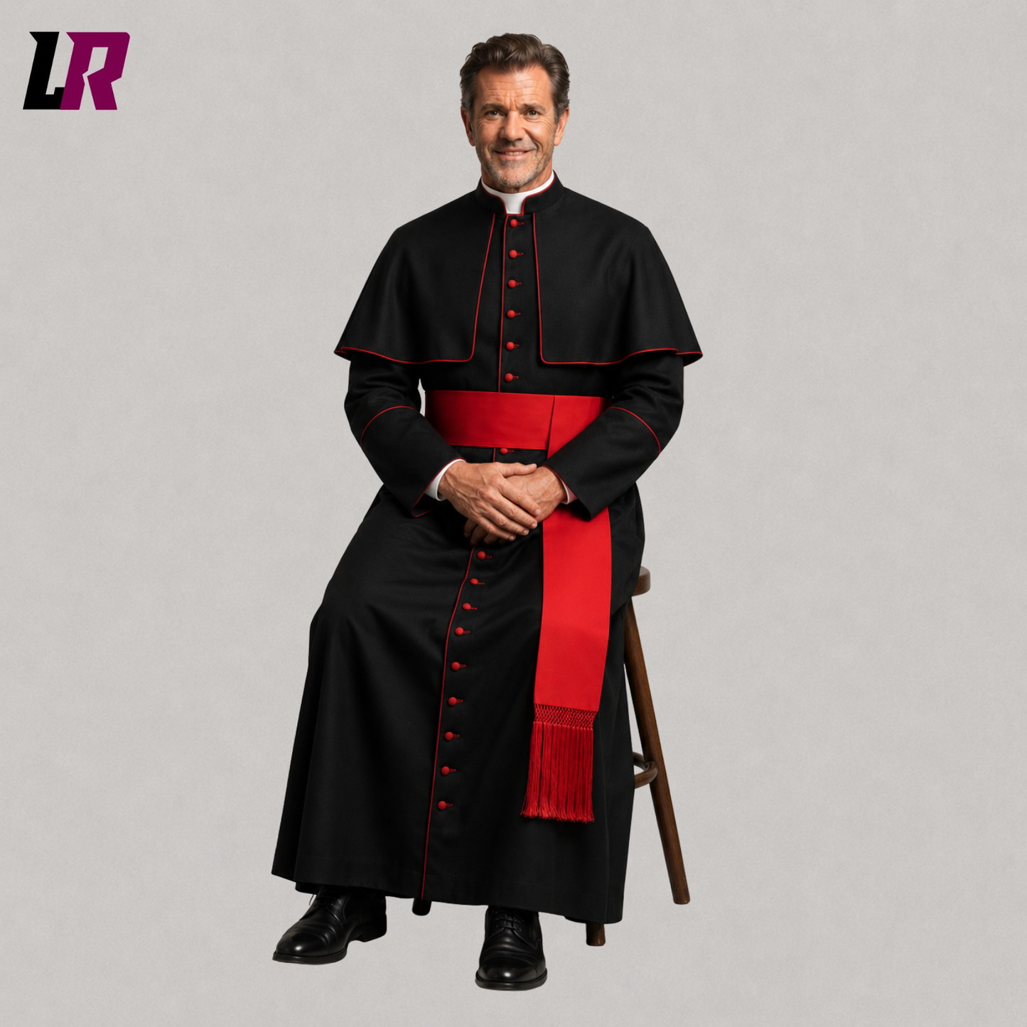 Priest wearing a custom black cassock with red piping seated on a stool in a formal portrait