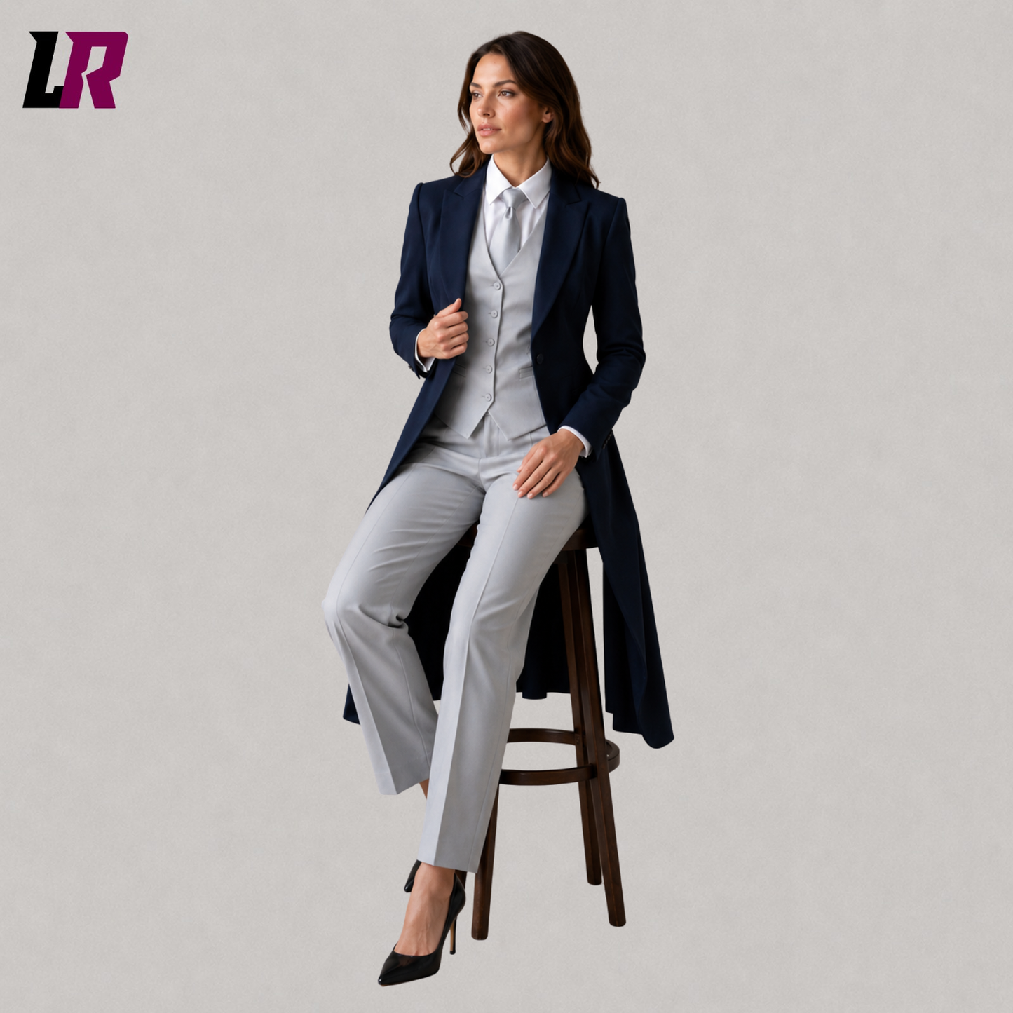 Woman wearing a navy blue Victorian Regency tailcoat suit seated on a stool in a formal portrait