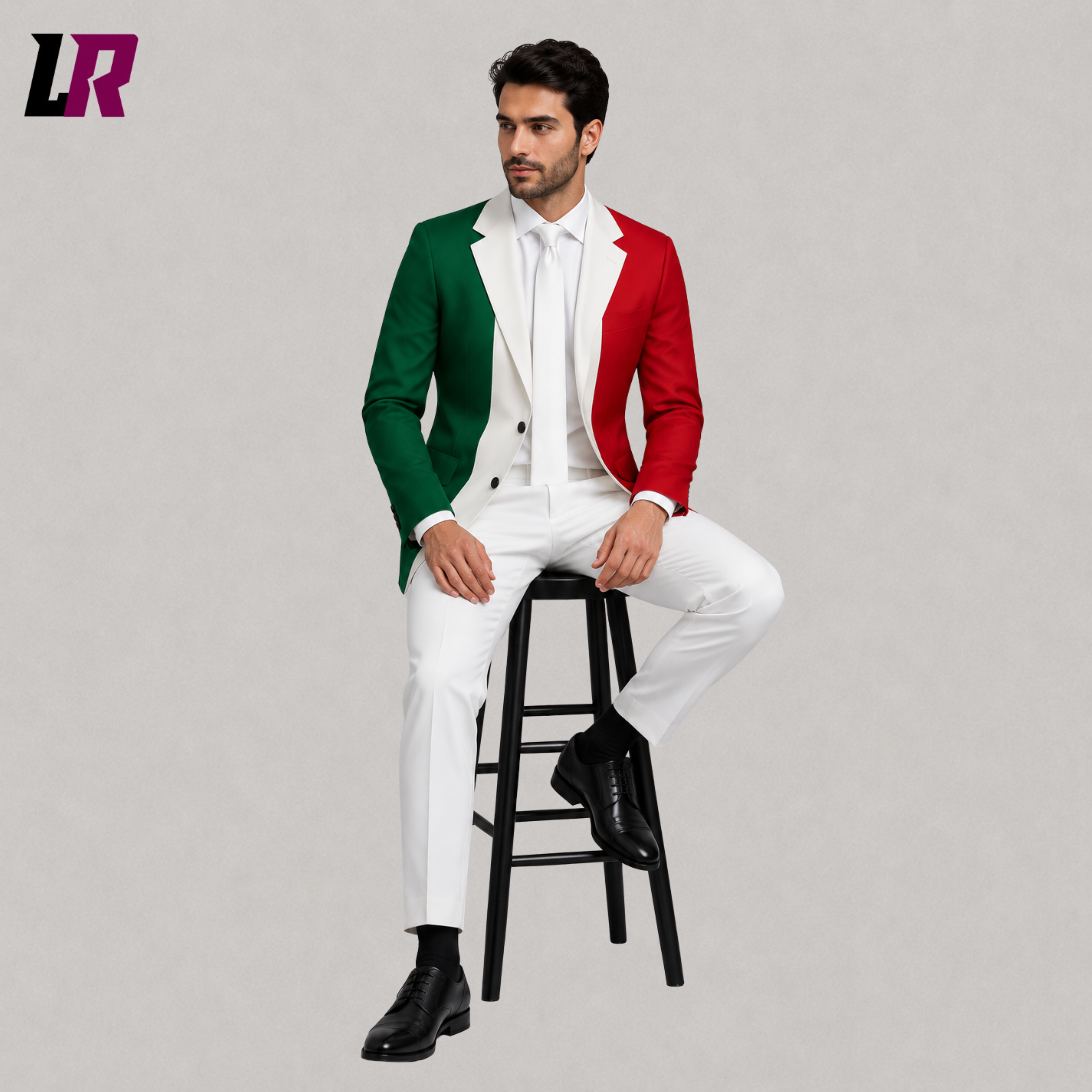 Man wearing a custom tailored Italian Flag Suit while sitting on a stool in a modern studio portrait