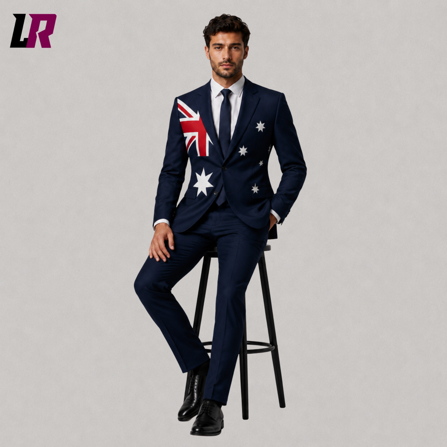 Man wearing a custom Australia Flag Suit while sitting on a stool in a modern studio portrait