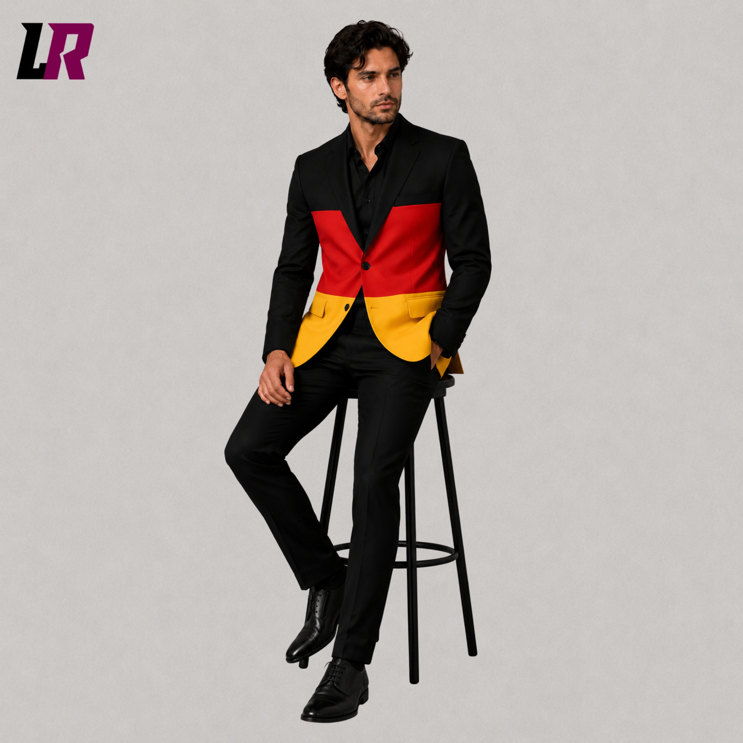 Man wearing a custom tailored German Flag Suit while sitting on a stool in a modern studio portrait