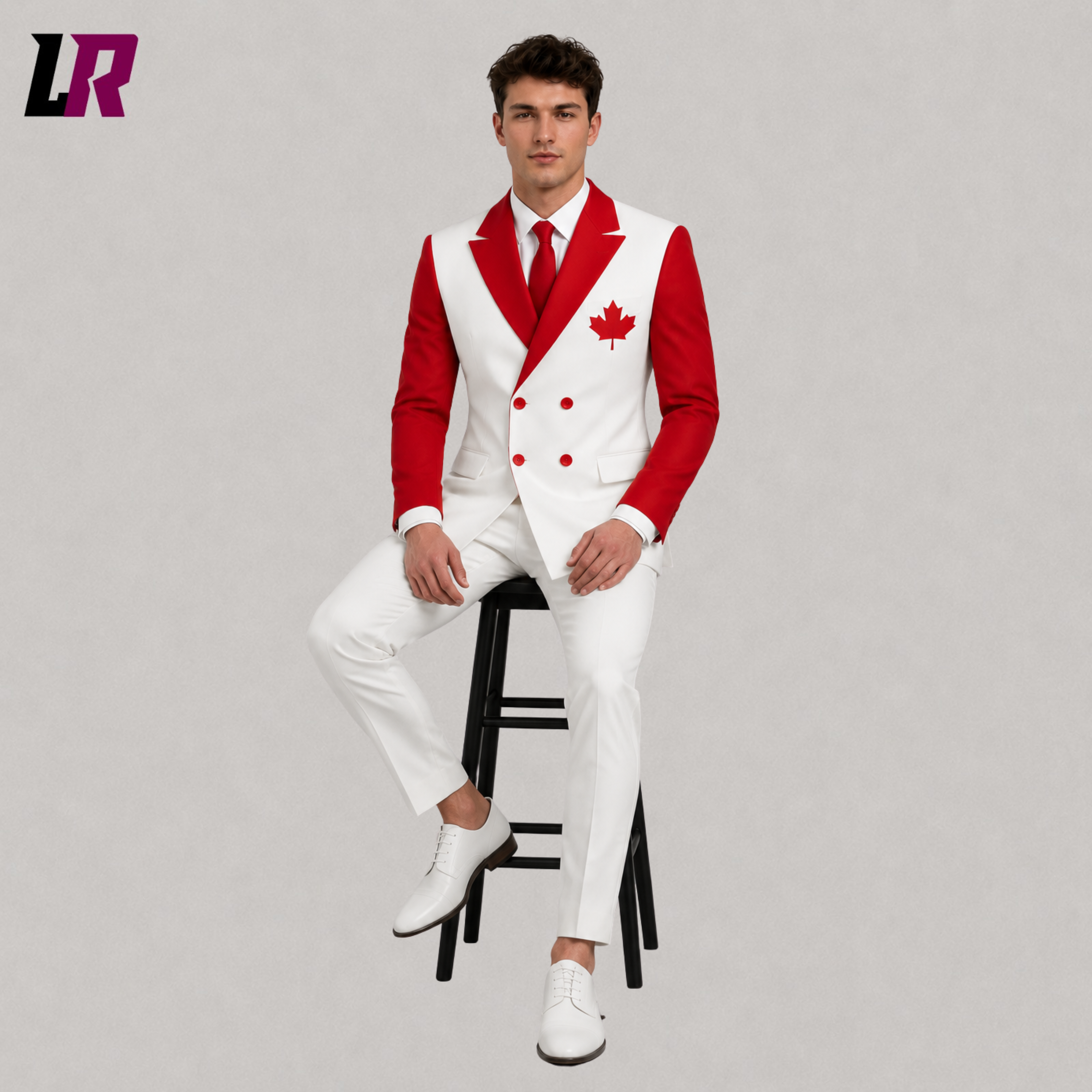 Man wearing a custom Canada Flag Suit while sitting on a stool in a modern studio portrait