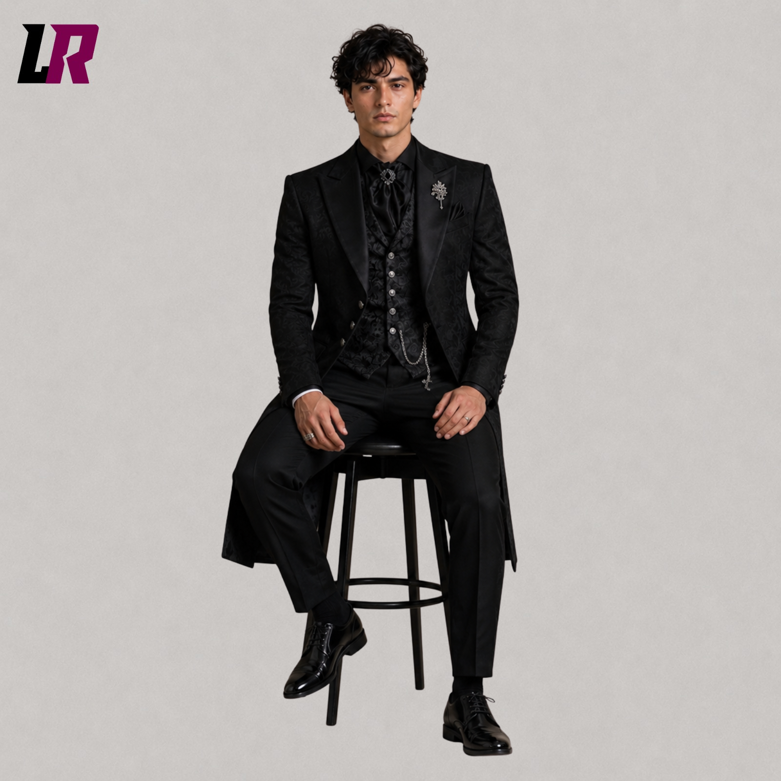 Men's black Victorian Gothic 3-piece tailcoat suit with model seated on a stool in a luxury formal fashion pose