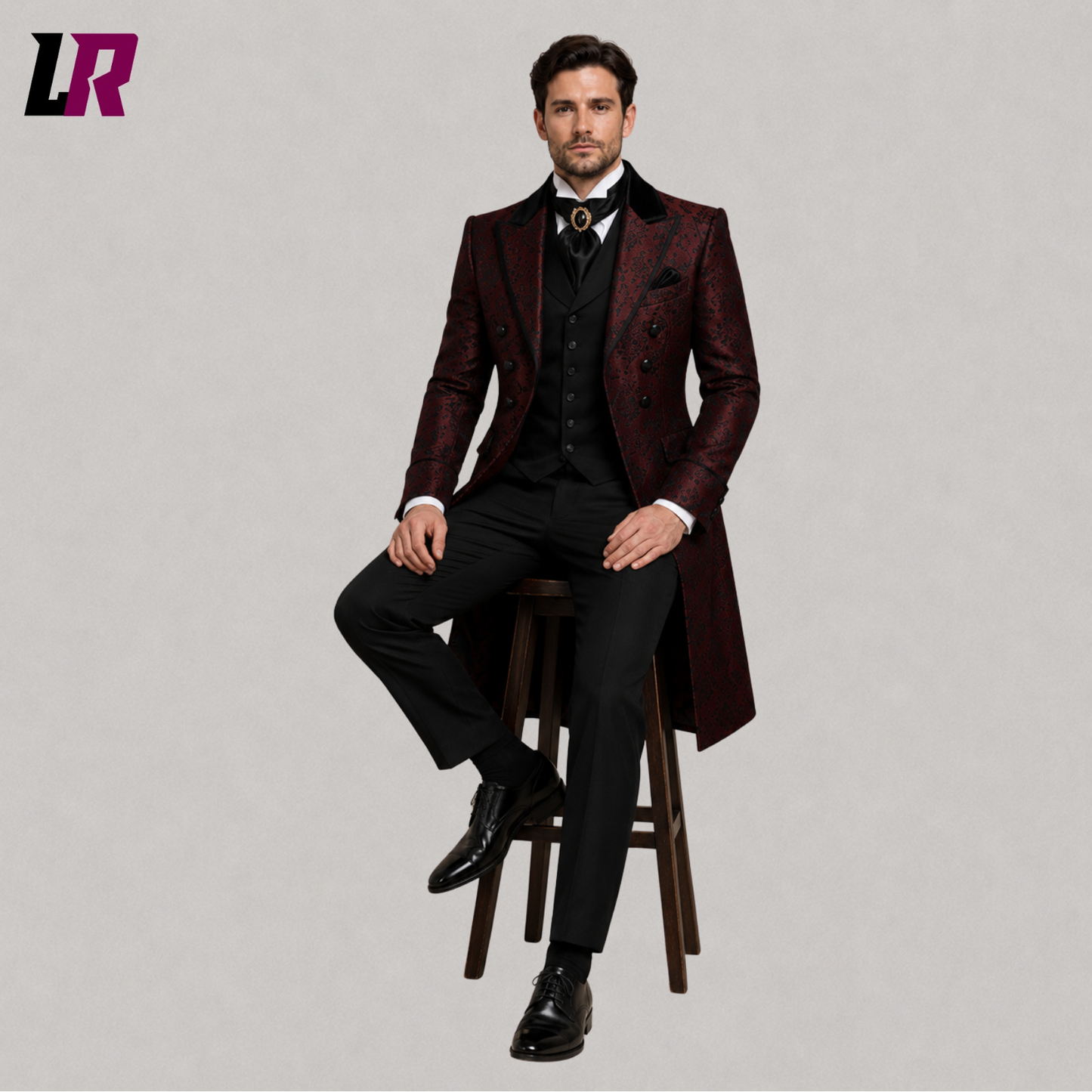Men's red Gothic Victorian tailcoat suit with model seated on a stool in a luxury formal fashion pose