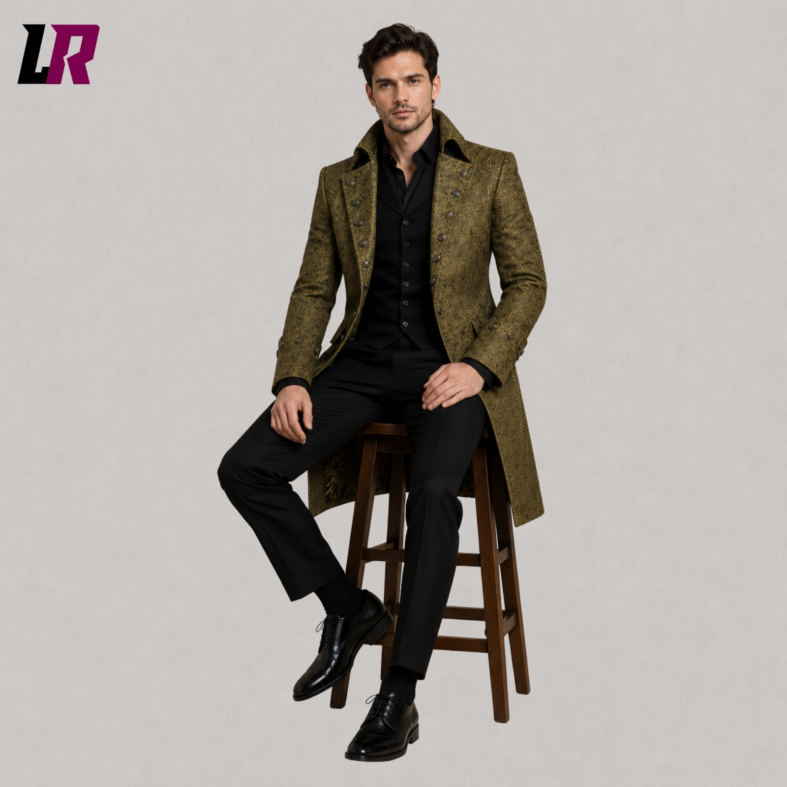 Men's olive green Victorian Gothic brocade long coat with model seated on a stool in a luxury formal fashion pose