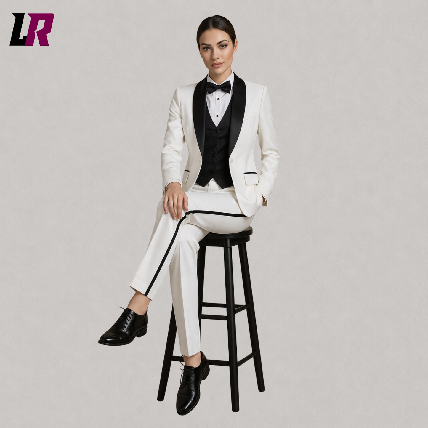 Woman sitting on stool wearing a luxury white tuxedo suit with black lapel, stylish formal fashion look