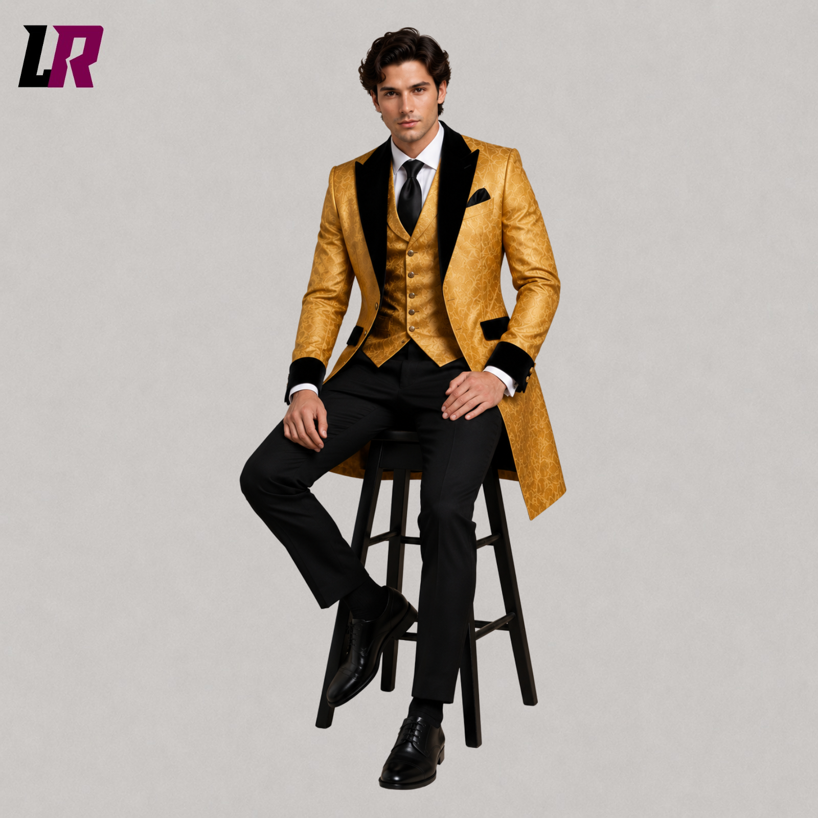 Man sitting on a stool wearing a black and gold Victorian tailcoat suit for weddings and formal events