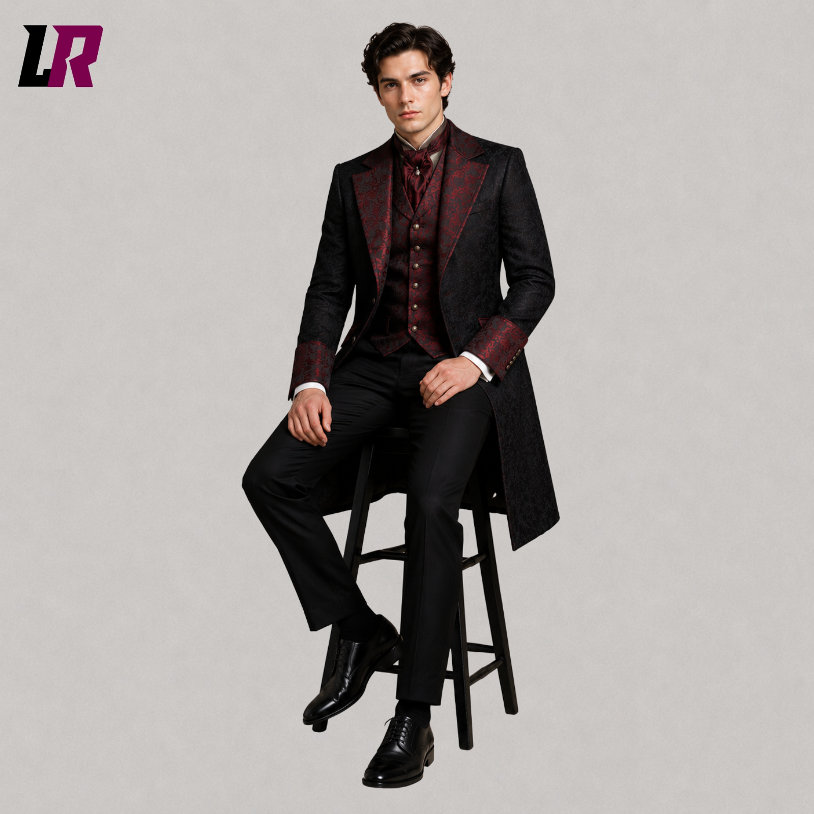 Man sitting on a stool wearing a black and red Victorian Gothic tailcoat for weddings and formal occasions