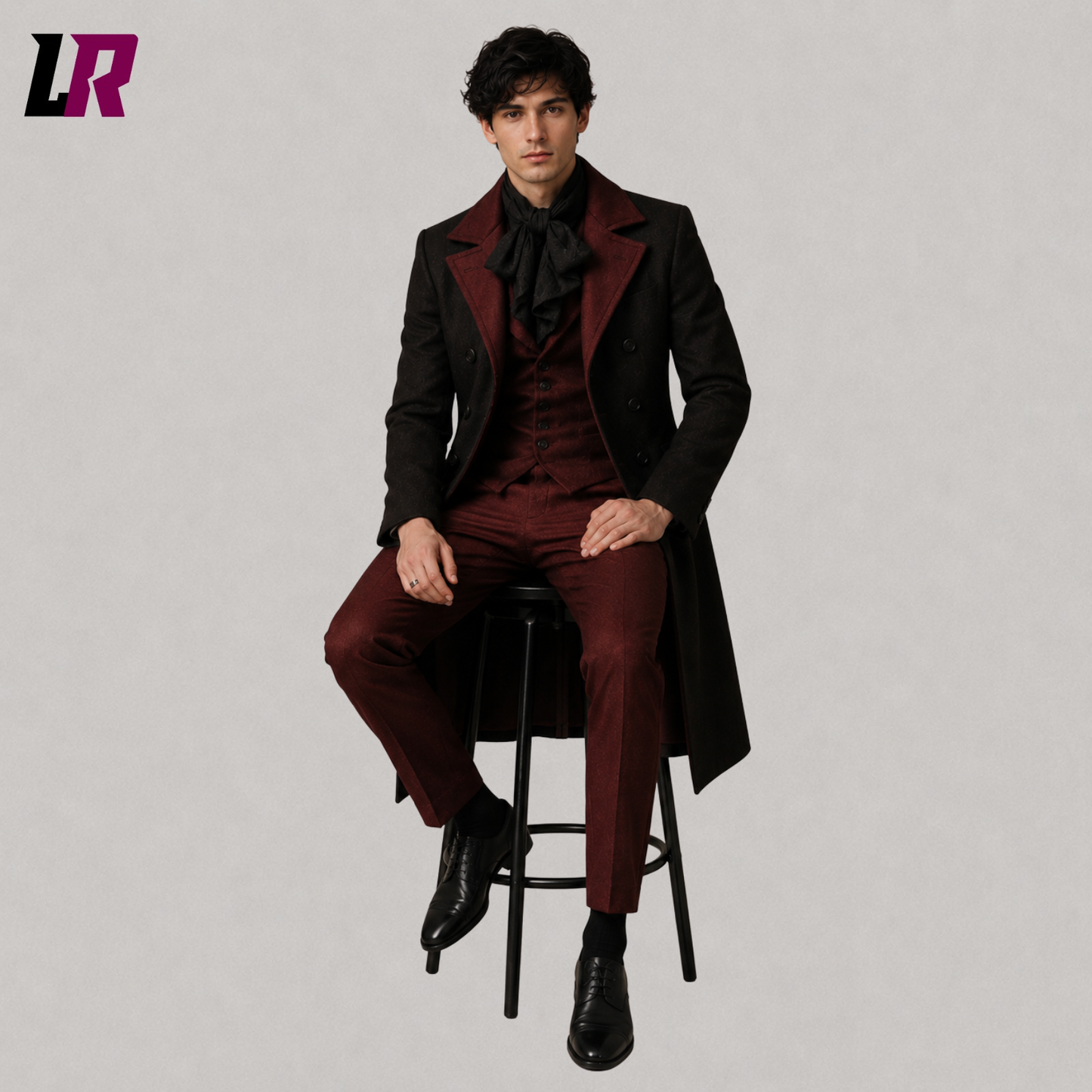 Man sitting on a stool wearing a Gothic Victorian 3-piece tailcoat suit for weddings and formal occasions