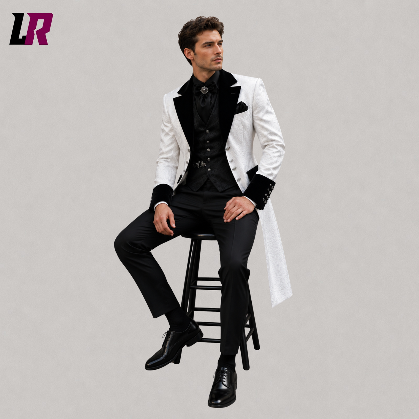 Man sitting on a stool wearing a white Victorian Gothic 3-piece tailcoat suit for weddings and formal occasions