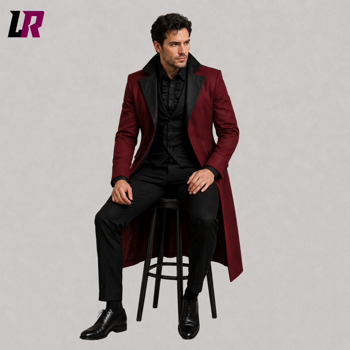 Man sitting on a stool wearing a burgundy Victorian Gothic tailcoat for weddings and formal occasions