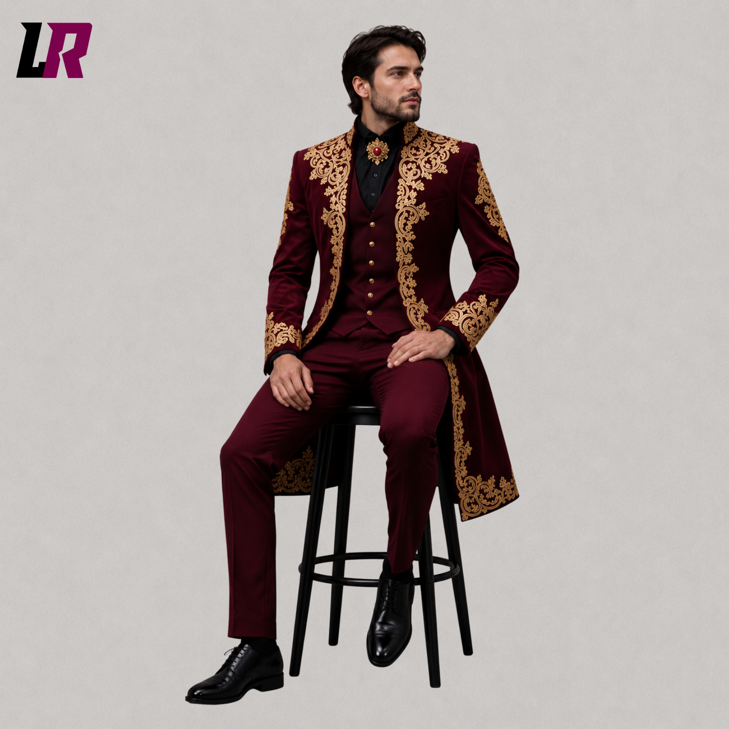 Man sitting on a stool wearing a burgundy velvet Gothic Victorian 3-piece suit for weddings and formal occasions