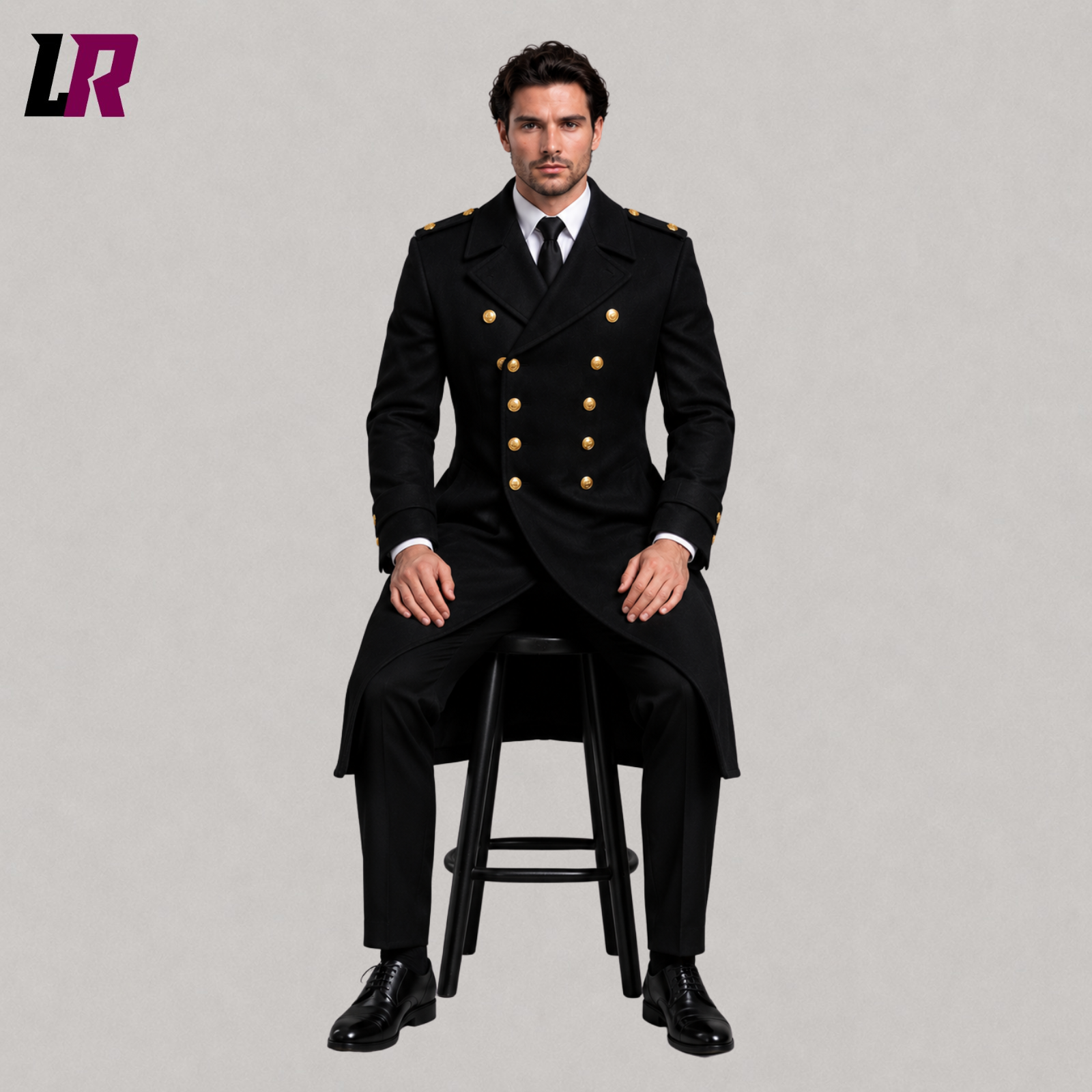 Man sitting on a stool wearing a black military style wool trench coat for winter formal occasions