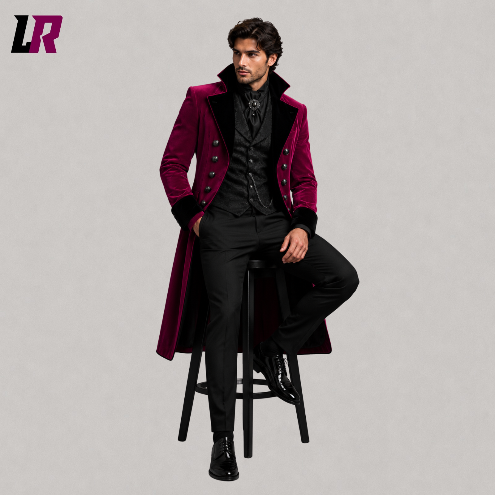 Man sitting on a stool wearing a magenta Gothic Victorian 3-piece tailcoat suit for weddings and formal occasions