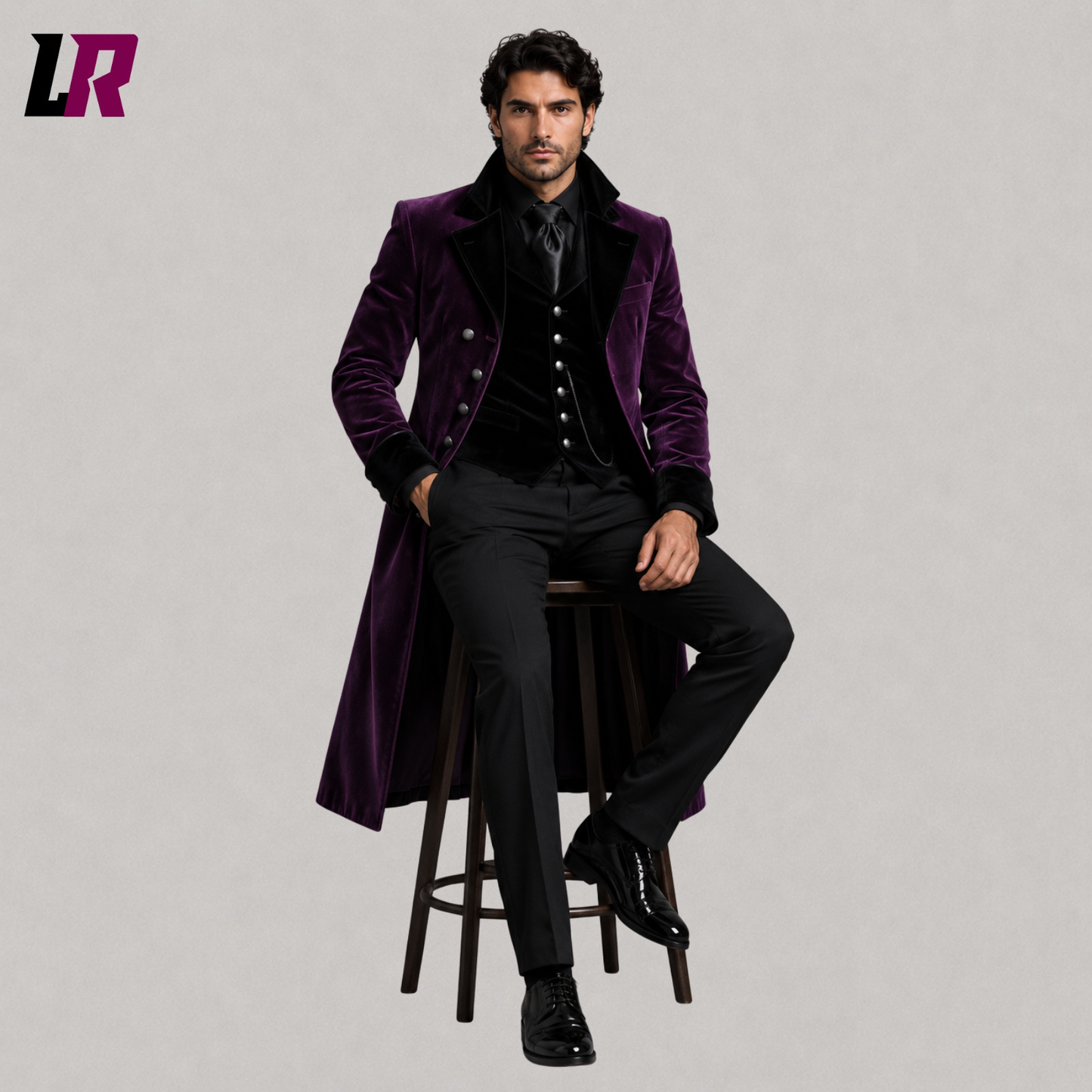Man sitting on a stool wearing a purple velvet Gothic Victorian 3-piece tailcoat suit for weddings and formal occasions