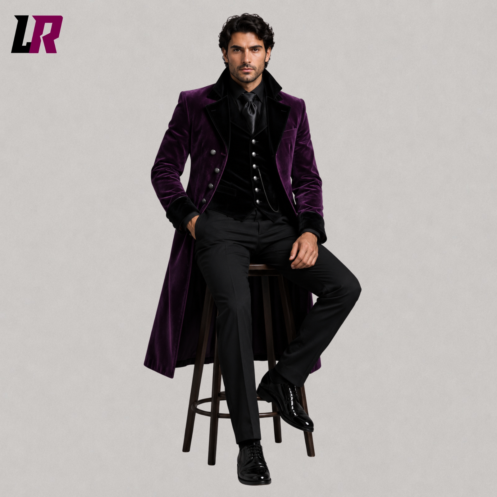 Man sitting on a stool wearing a purple velvet Gothic Victorian 3-piece tailcoat suit for weddings and formal occasions