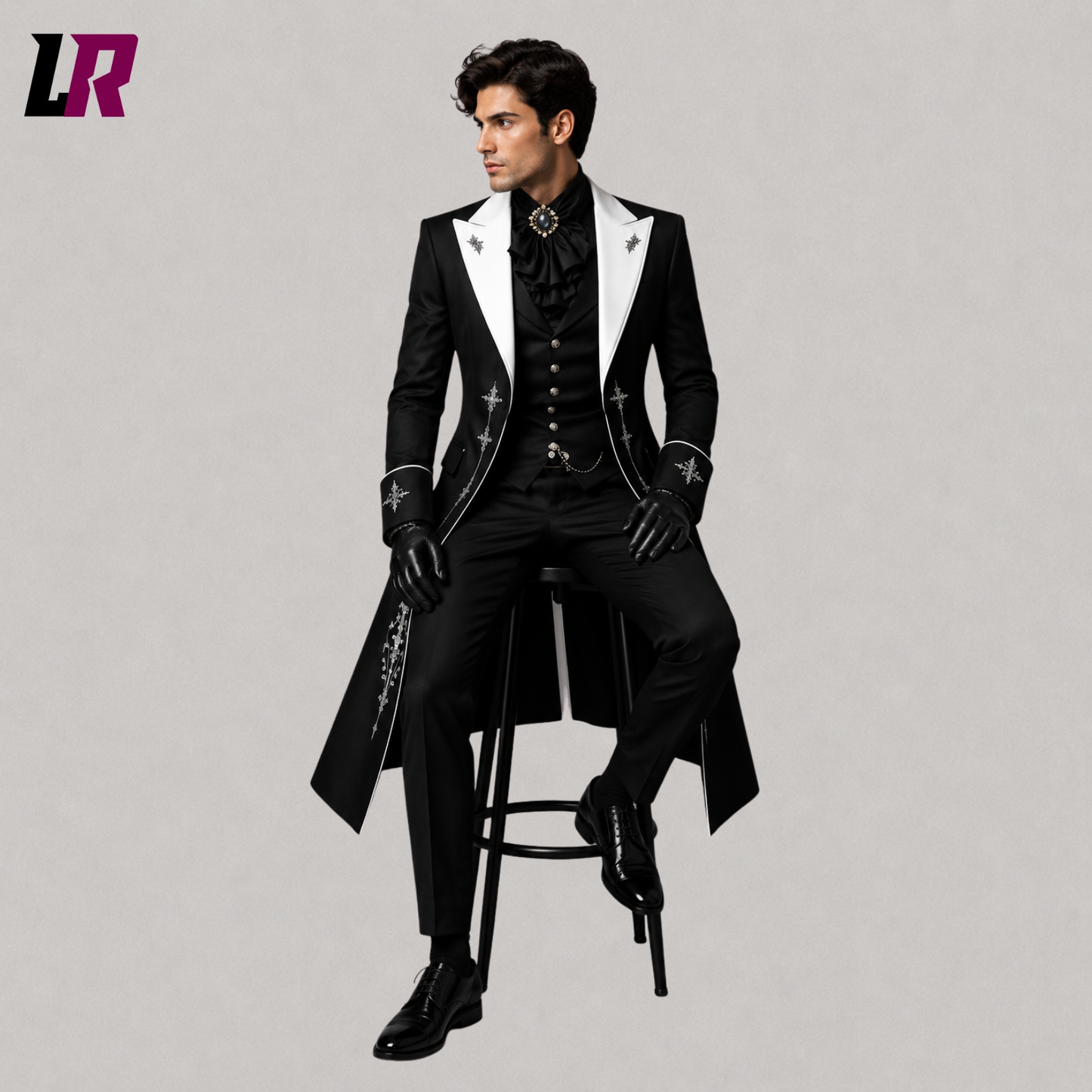 Man sitting on a stool wearing a black embroidered Victorian Gothic 3-piece tailcoat suit for weddings and formal occasions