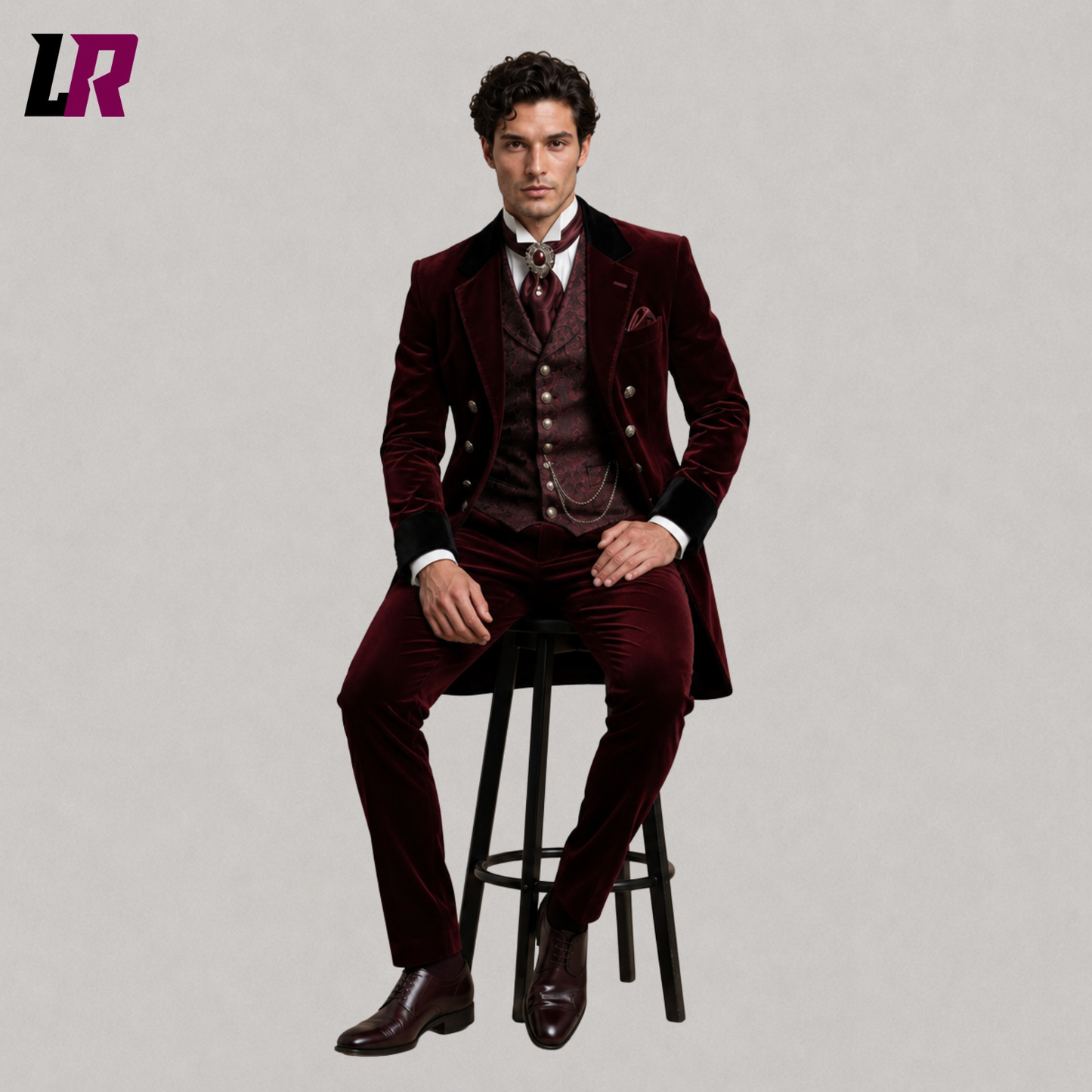 Man sitting on a stool wearing a burgundy velvet Victorian Gothic 3-piece tailcoat suit for weddings and formal occasions