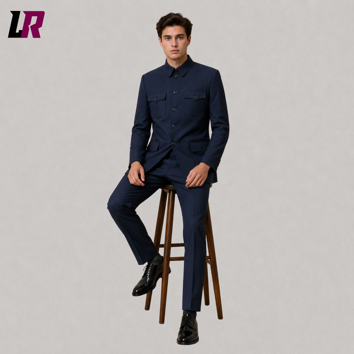 Man sitting on a stool wearing a navy blue Mandarin collar military tunic suit for weddings and formal occasions