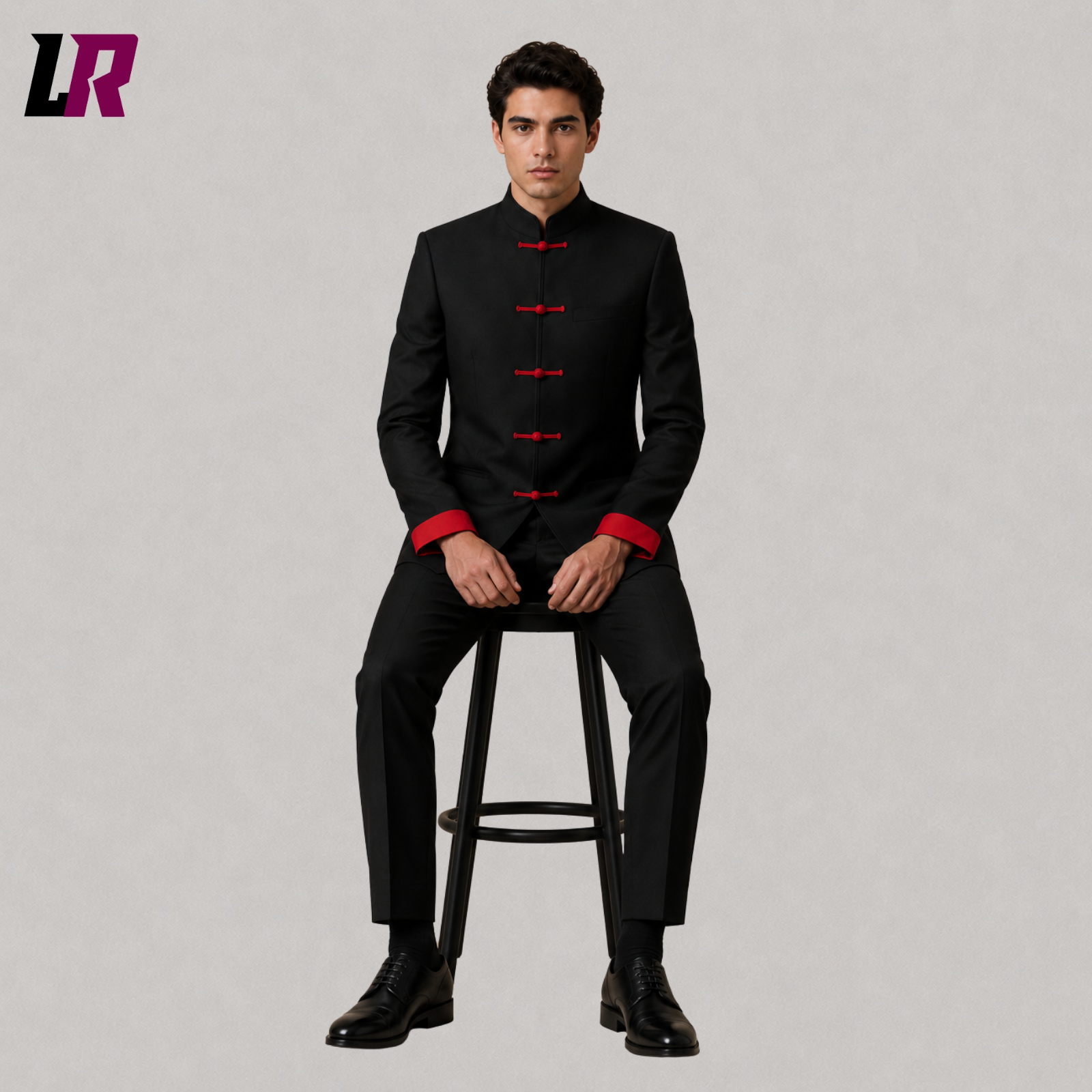 Man sitting on a stool wearing a black Mandarin collar formal suit for weddings and elegant occasions