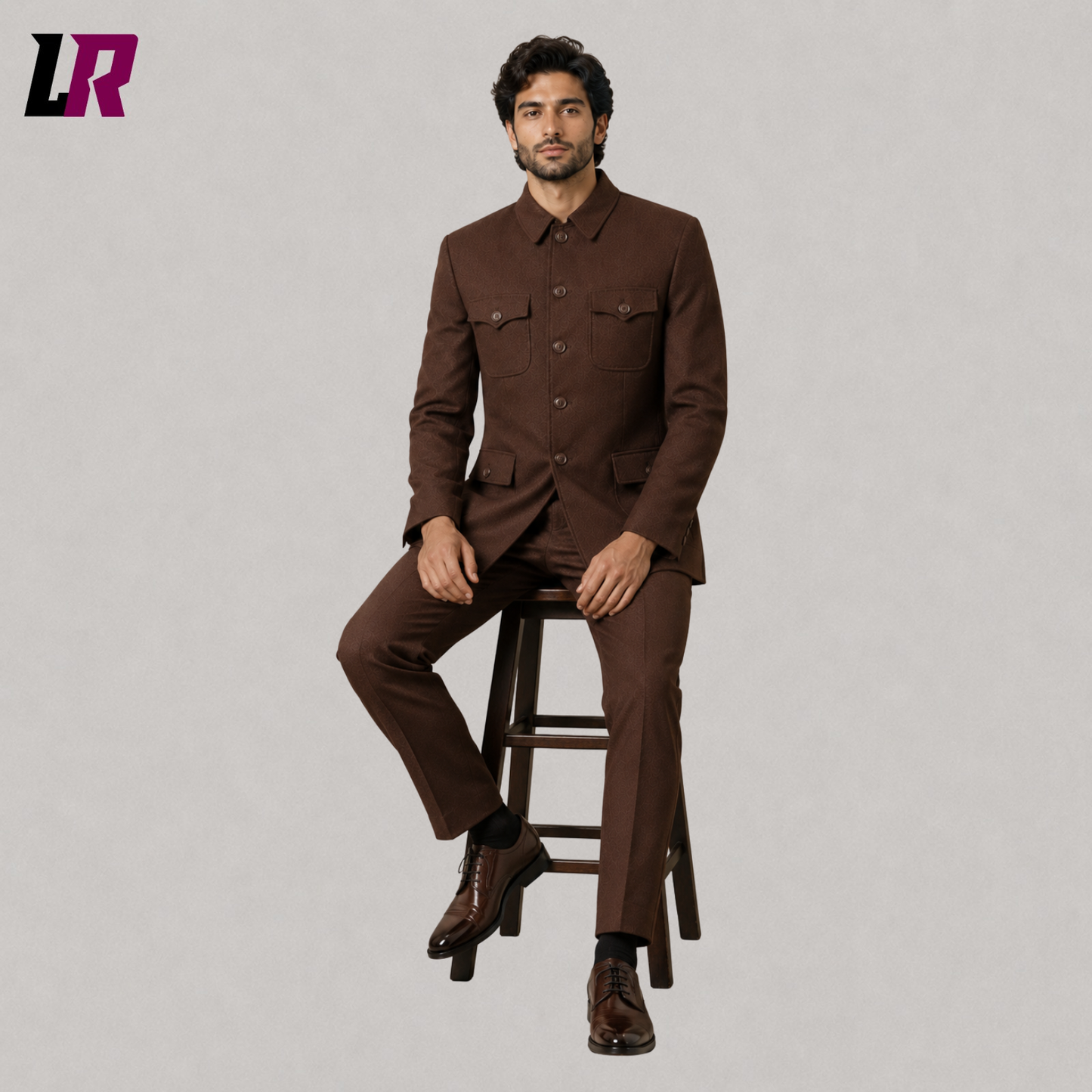 Man sitting on a stool wearing a brown safari military-style formal suit for weddings and luxury occasions