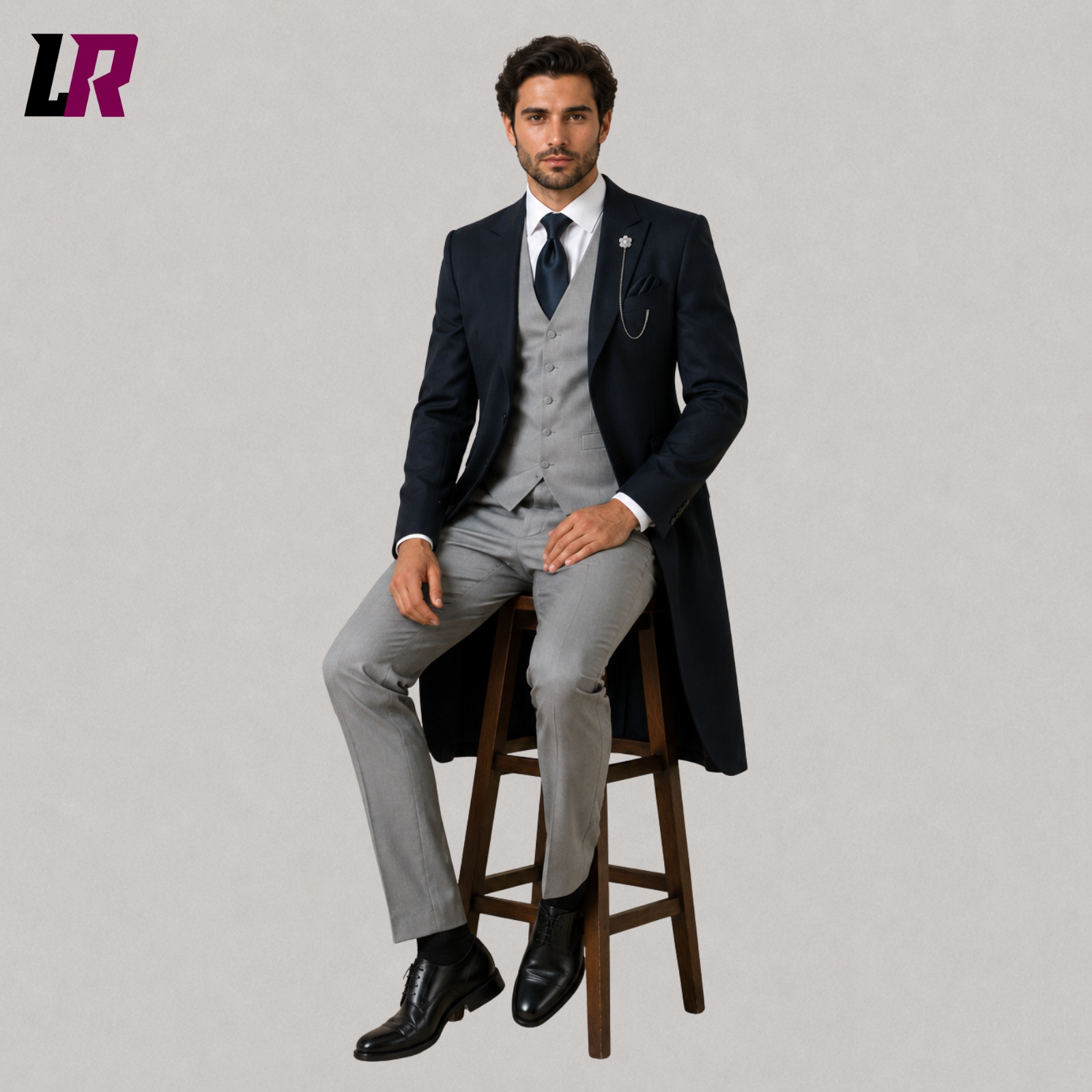 Man sitting on a stool wearing a navy blue Victorian 3-piece morning suit for weddings and formal occasions