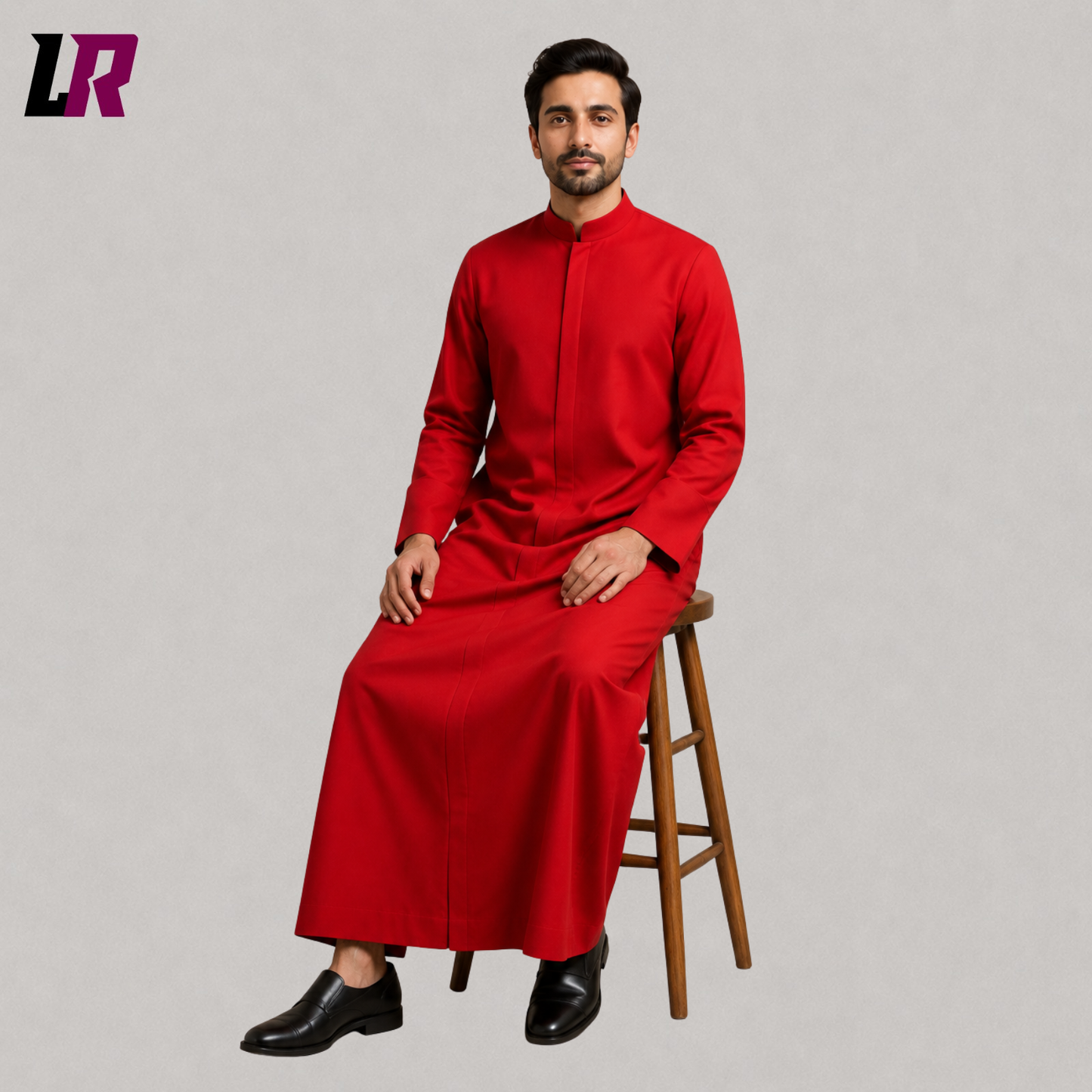 Man sitting on a stool wearing a custom-tailored red Anglican clergy cassock for church services and liturgical ceremonies