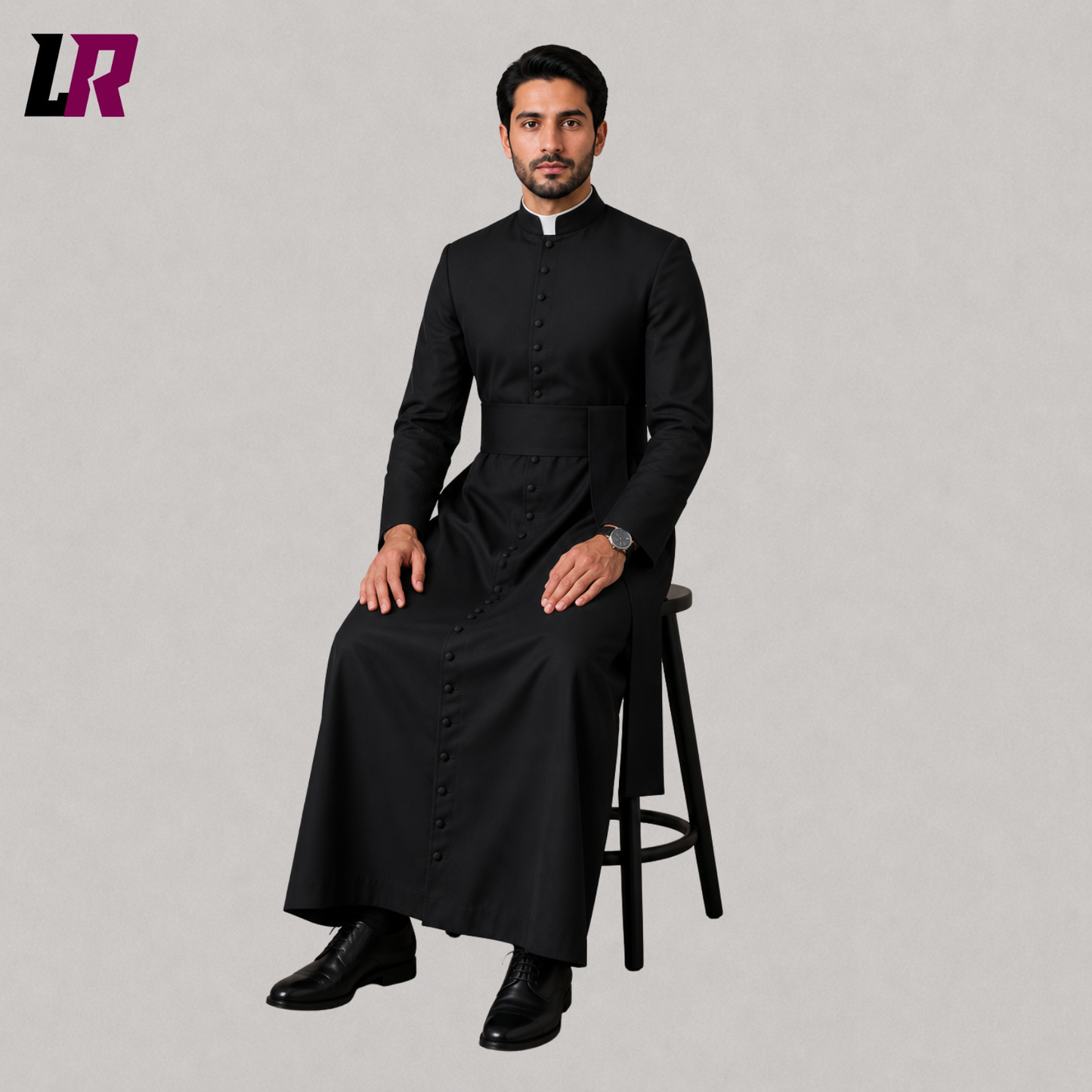 Priest sitting on a stool wearing a custom black Catholic cassock for Holy Mass and church services