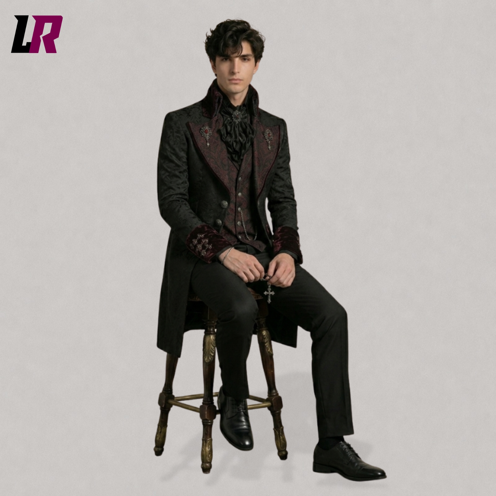 Full body seated portrait of a man wearing a black Gothic Victorian tailcoat 3 piece tuxedo set
