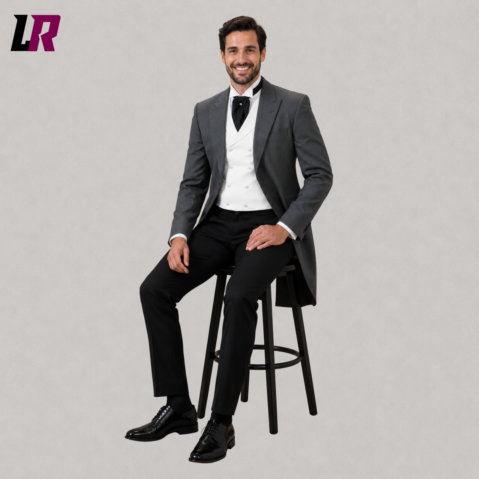 Man wearing a grey Victorian morning tailcoat suit seated on a stool in a formal portrait
