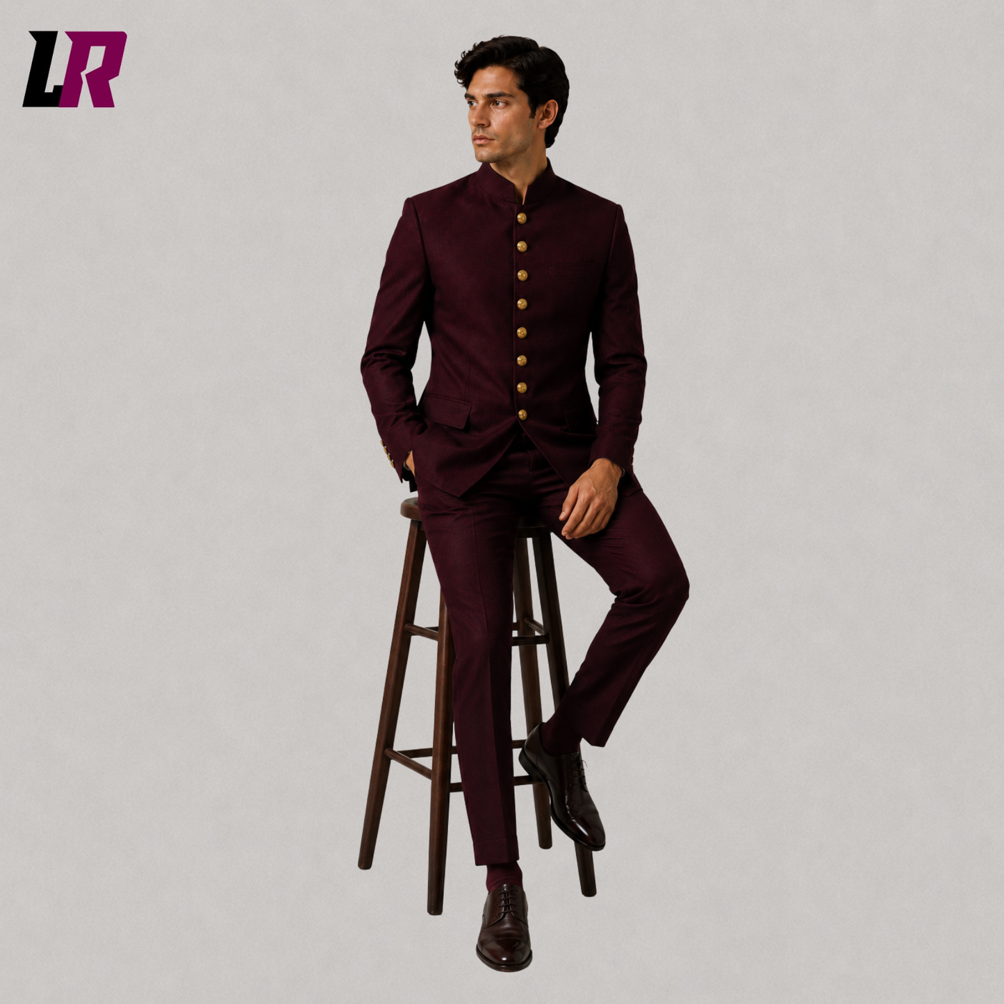 Man wearing a burgundy Chinese tunic Bandhgala suit seated on a stool in a Victorian Gothic Regency jacket