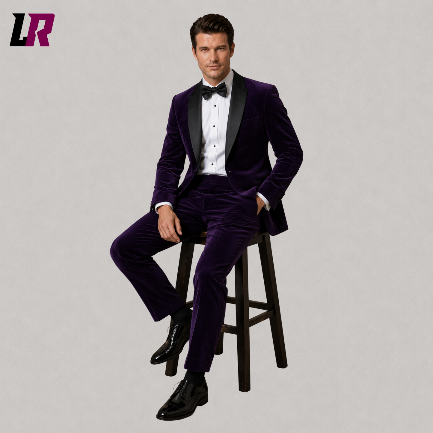 Man wearing a purple velvet dinner jacket suit seated on a stool in a luxury formal portrait
