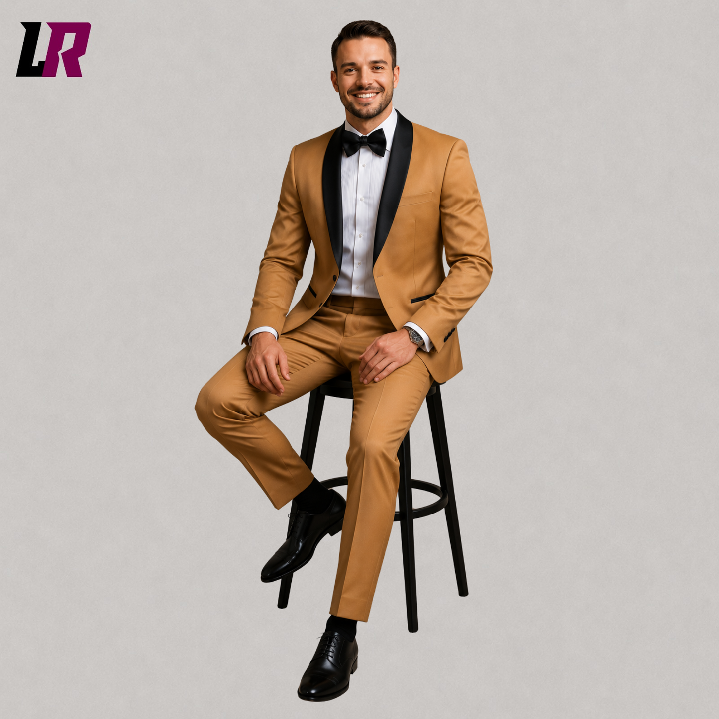 Man wearing a camel tuxedo suit seated on a stool in a luxury formal portrait