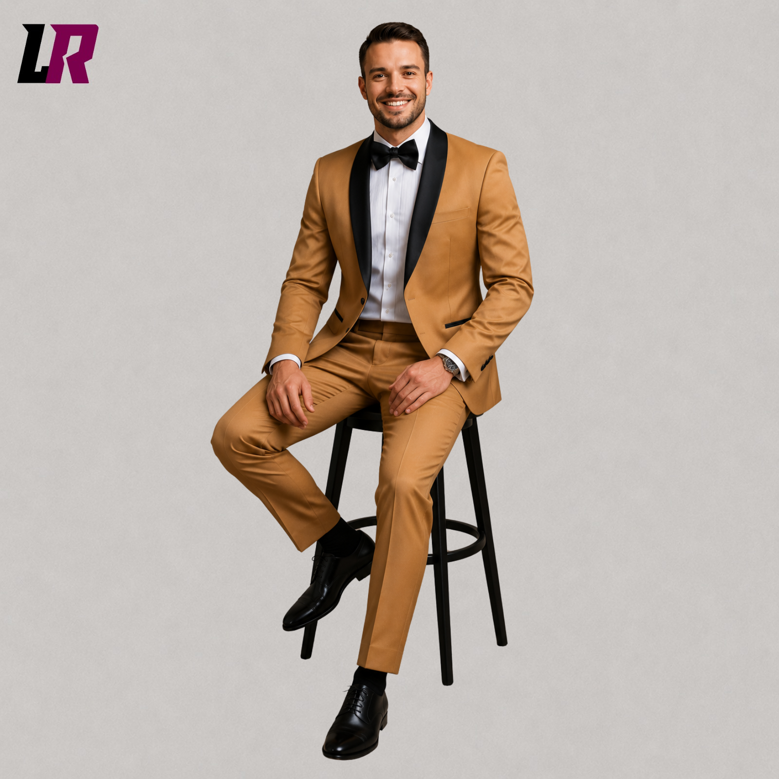 Man wearing a camel tuxedo suit seated on a stool in a luxury formal portrait