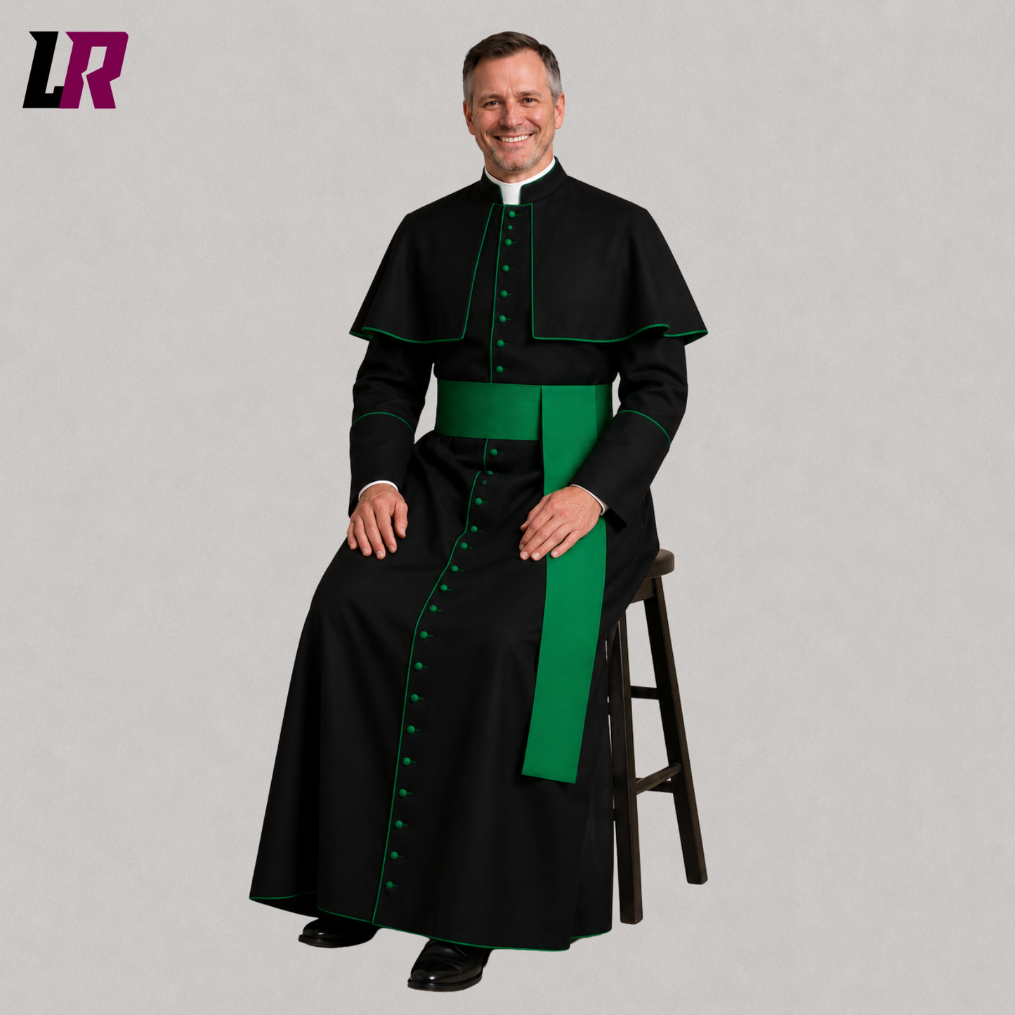 Priest wearing a traditional Catholic cassock with green piping seated on a stool in a formal portrait