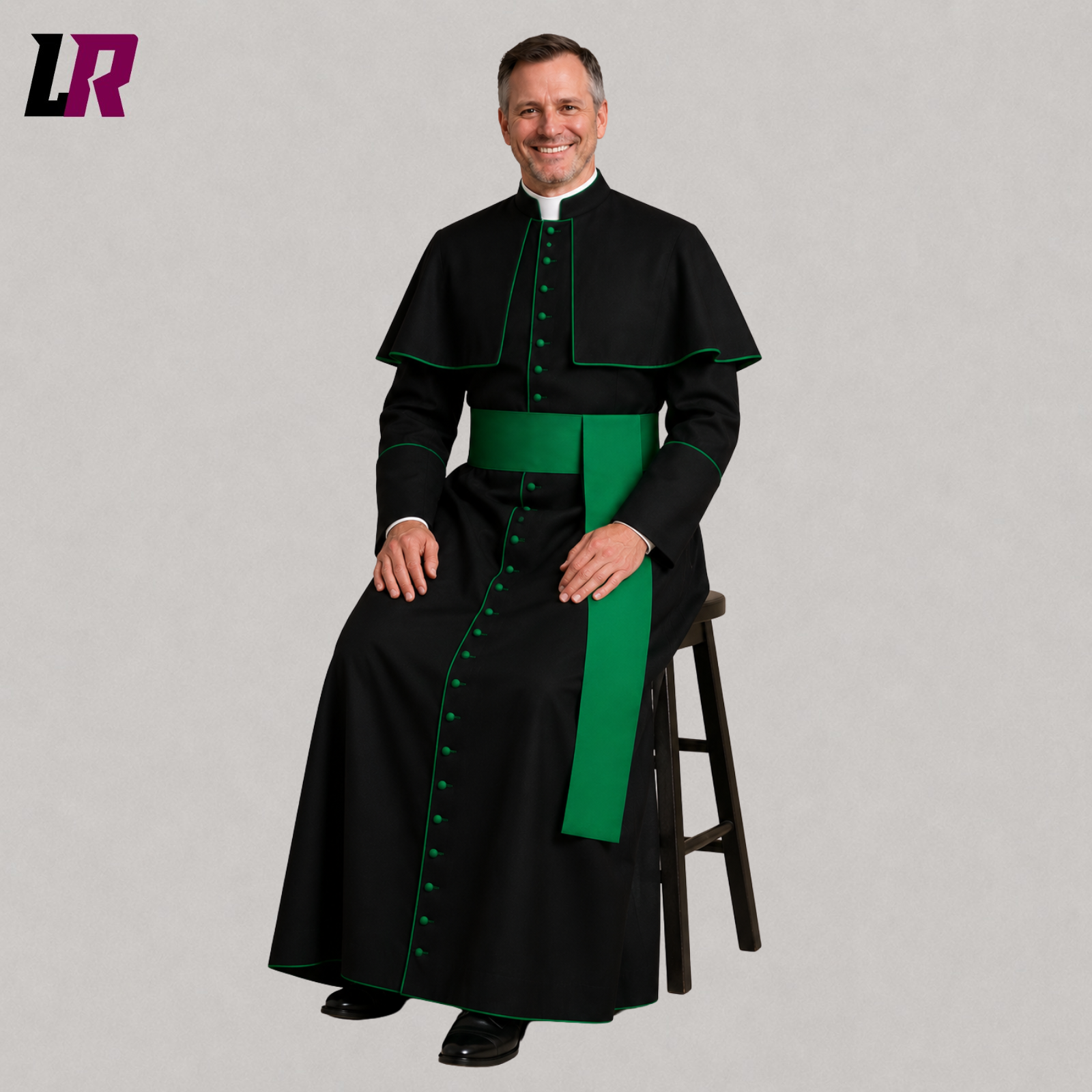 Priest wearing a traditional Catholic cassock with green piping seated on a stool in a formal portrait