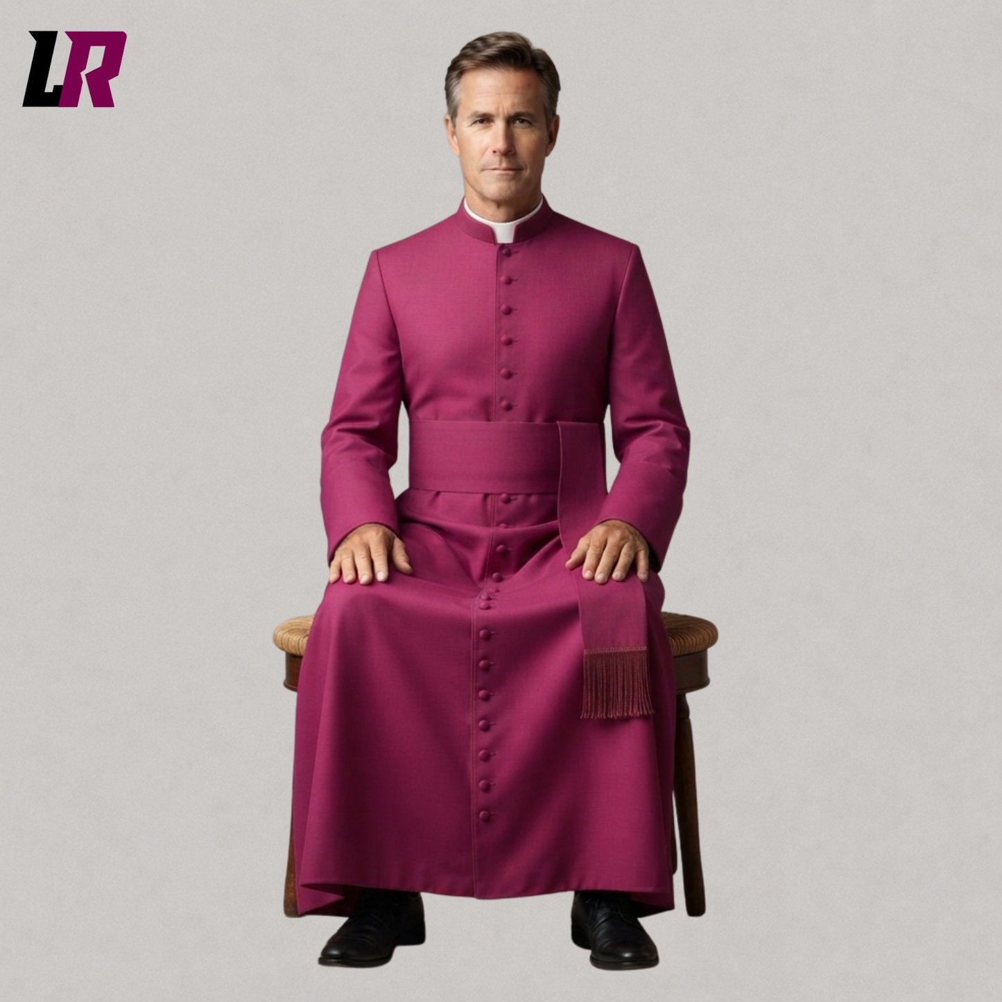 Clergy member wearing a handmade bishop cassock with fuchsia trim seated on a stool in a formal portrait