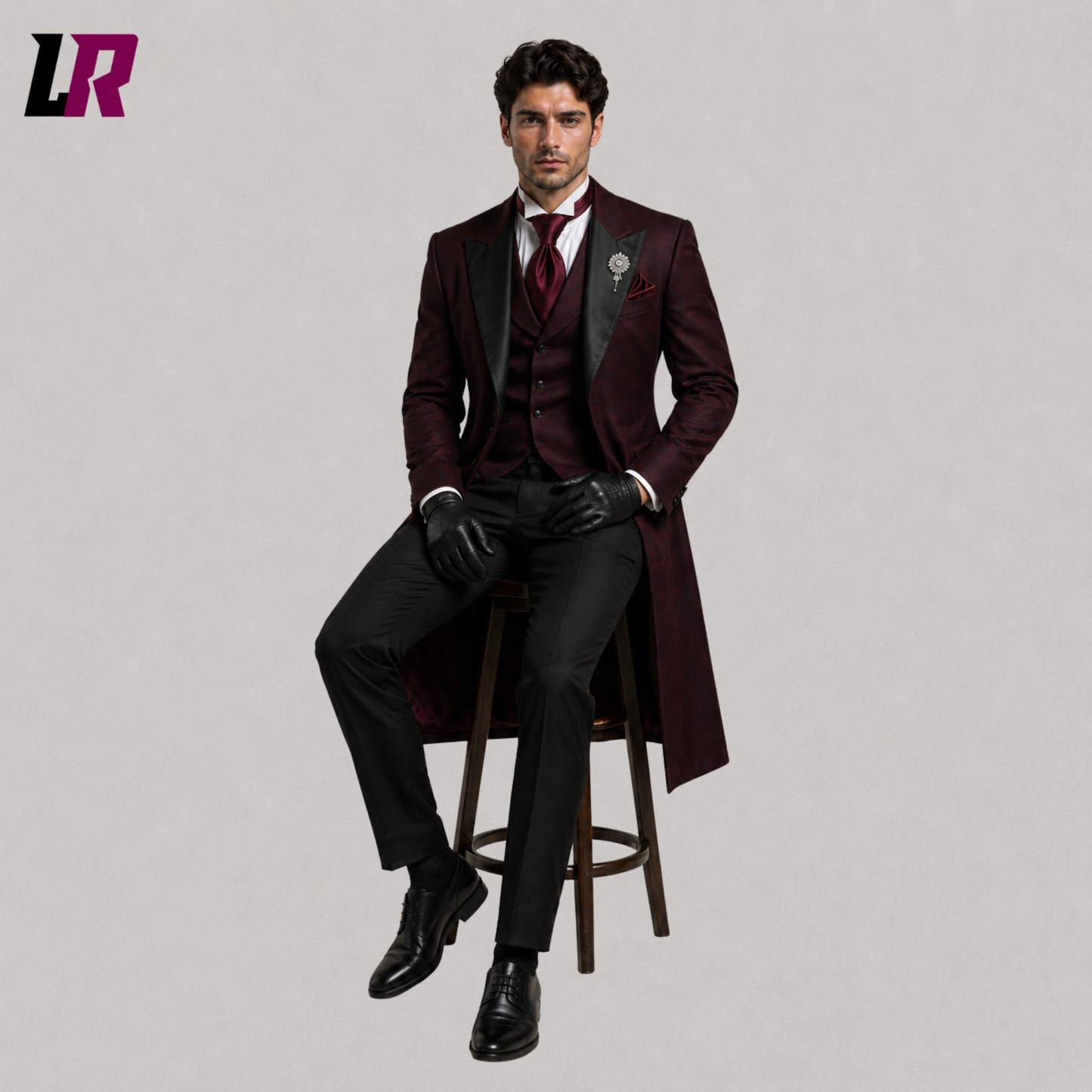 Men's burgundy Victorian Gothic tailcoat suit with model seated on a stool in a luxury formal fashion pose