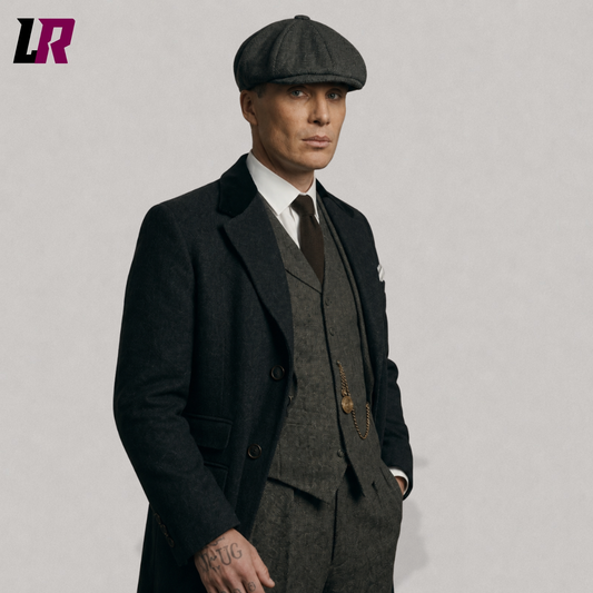 Close-up of a men's vintage tweed suit with black overcoat and flat cap in classic 1920s style